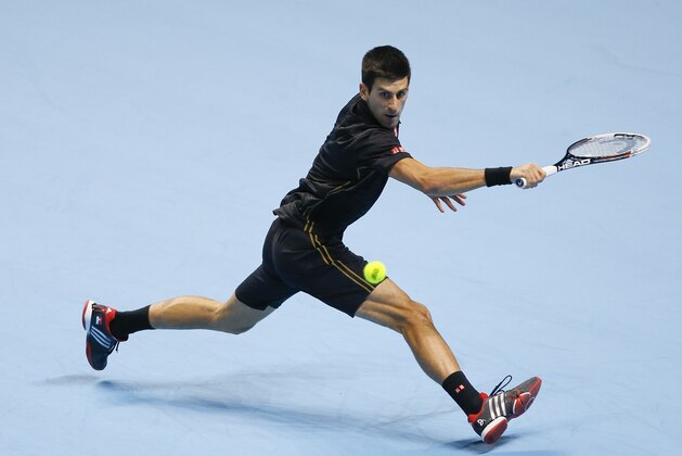 Serbia’s Novak Djokovic plays a return to Japan’s Kei Nishikori during their singles ATP World Tour Finals semifinal tennis match at the O2 Arena in London, Saturday, Nov. 15, 2014. (AP Photo/Kirsty Wigglesworth)