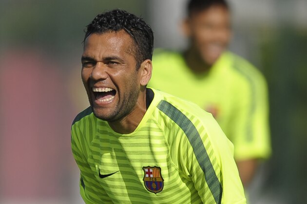 FC Barcelona's Dani Alves, from Brazil, laughs during a training session at the Sports Center FC Barcelona Joan Gamper in San Joan Despi, Spain, Monday, Oct. 20, 2014. FC Barcelona will play against Ajax in a group F Champions League on Tuesday Oct. 21. (AP Photo/Manu Fernandez)