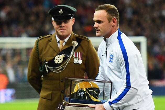 LONDON, ENGLAND - NOVEMBER 15:  Wayne Rooney of England is awarded his 100th cap by Sir Bobby Charlton (not in shot) prior to during the EURO 2016 Qualifier Group E match between England and Slovenia at Wembley Stadium on November 15, 2014 in London, England.  (Photo by Shaun Botterill/Getty Images)