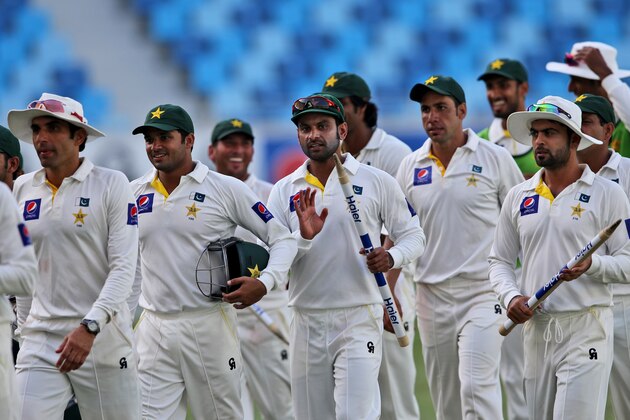 Pakistani players celebrate after they win Australia during day five of the First Test at Dubai International Stadium in United Arab Emirates, Sunday, Oct. 26, 2014. (AP Photo/Kamran Jebreili)