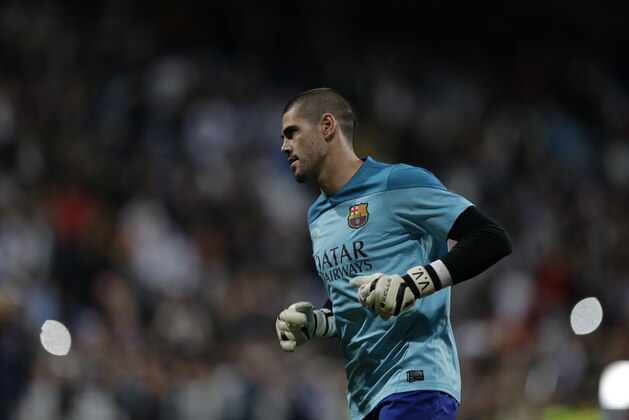 FC Barcelona's goalkeeper Victor Valdes warms up before a Spanish La Liga soccer match against Real Madrid at the Santiago Bernabeu stadium in Madrid, Sunday March 23, 2014. (AP Photo/Paul White)