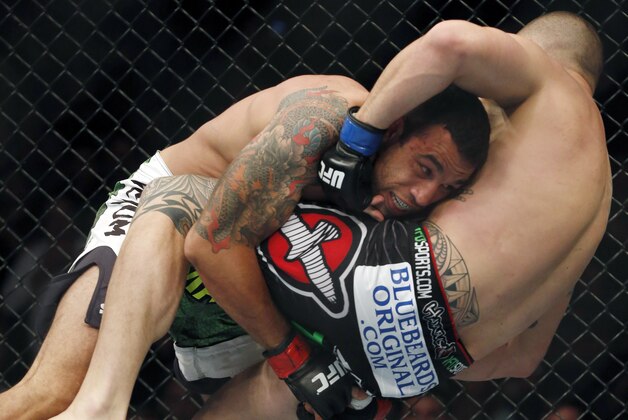 Fabricio Werdum, left, and Travis Browne fight  in the main event during a mixed martial arts event on Saturday, April 19, 2014, at UFC Fight Night in Orlando Fla.  Werdum won in a decision. (AP Photo/Reinhold Matay)
