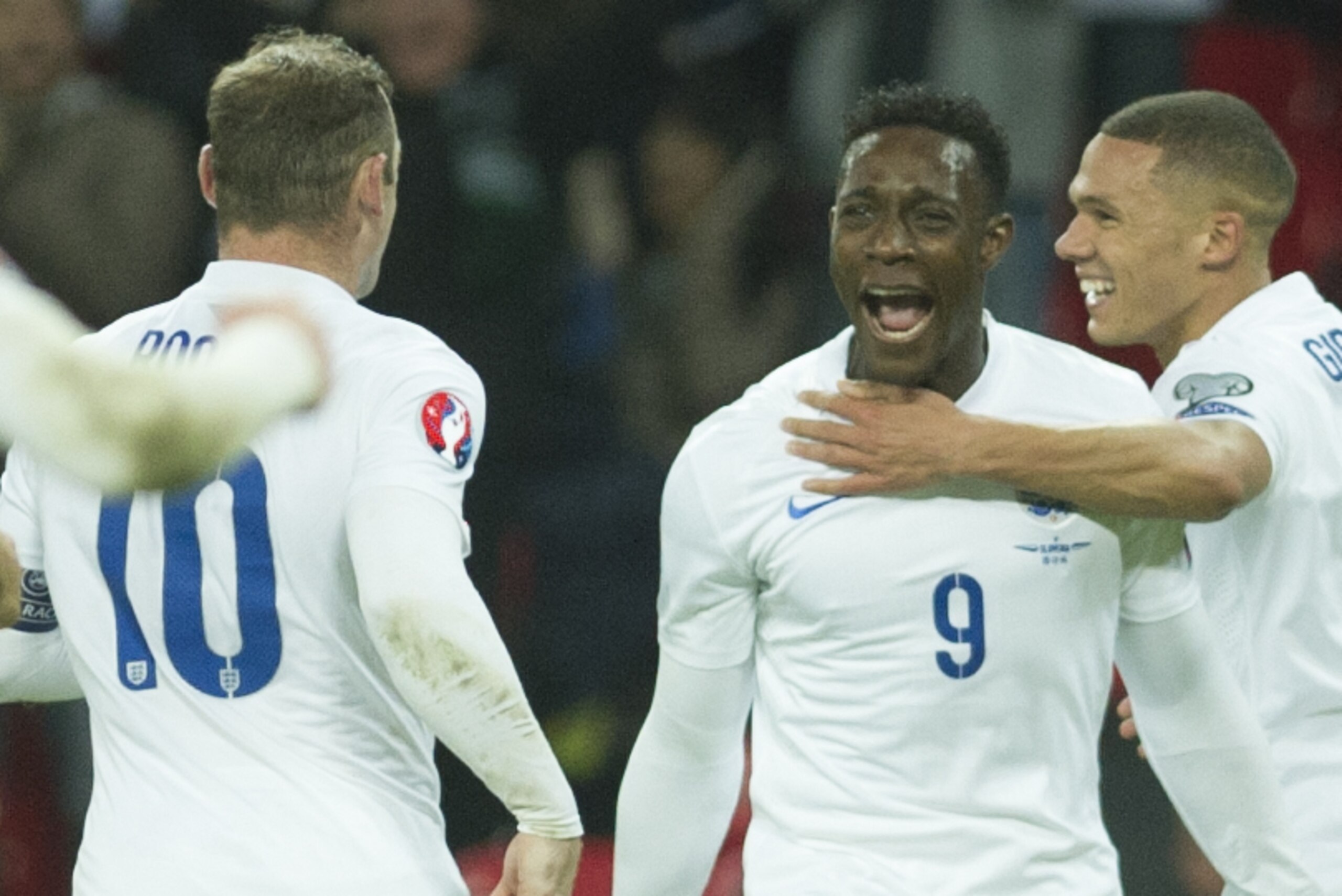 England's Danny Welbeck celebrates with team mates Wayne Rooney, left, and Kieran Gibbs after scoring against Slovenia, during their Euro 2016 Group E qualifying soccer match at Wembley Stadium, London, Saturday, Nov. 15, 2014 (AP Photo/Bogdan Maran)