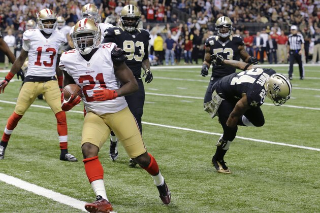 San Francisco 49ers running back Frank Gore (21) scores on a touchdown carry past New Orleans Saints cornerback Corey White (24) in the first half of an NFL football game in New Orleans, Sunday, Nov. 9, 2014. (AP Photo/Bill Haber)