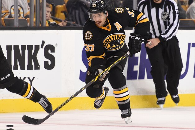 BOSTON, MA - NOVEMBER 15 : Brad Marchand #63 and Patrice Bergeron #37 of the Boston Bruins skate against the Carolina Hurricanes at the TD Garden on November 15, 2014 in Boston, Massachusetts.  (Photo by Brian Babineau/NHLI via Getty Images)