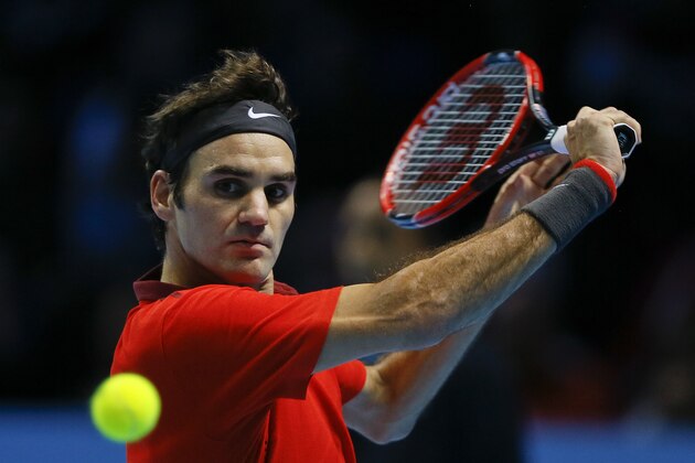 Switzerland’s Roger Federer plays a return to Switzerland’s Stan Wawrinka during their singles ATP World Tour Finals semifinal tennis match at the O2 Arena in London, Saturday, Nov. 15, 2014. (AP Photo/Kirsty Wigglesworth)