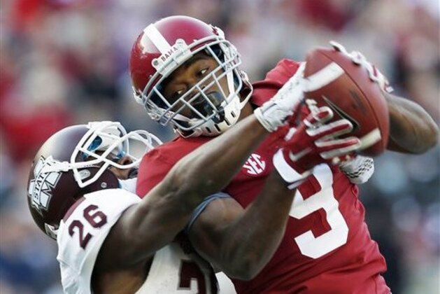 Alabama wide receiver Amari Cooper (9) catches a 50-yard pass against Mississippi State defensive back Kendrick Market (26) in the first half of an NCAA college football game on Saturday, Nov. 15, 2014, in Tuscaloosa, Ala. (AP Photo/Butch Dill)