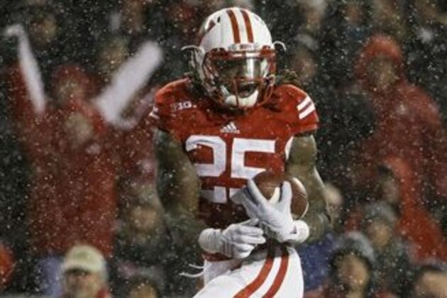 Wisconsin's Melvin Gordon scores on a 26-yard touchdown in the third quarter of an NCAA college football game against Nebraska Saturday, Nov. 15, 2014, in Madison, Wis. Gordon ran for 408 yards through three quarters Saturday, capping it off with this run to break the single-game major college football rushing record set on Nov. 20, 1999, when LaDanian Tomlinson with 406 yards on 43 carries for TCU against UTEP. (AP Photo/Morry Gash)