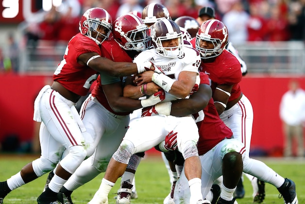 TUSCALOOSA, AL - NOVEMBER 15:  Dak Prescott #15 of the Mississippi State Bulldogs is tackled by Landon Collins #26, Dalvin Tomlinson #54 and Xzavier Dickson #47 of the Alabama Crimson Tide at Bryant-Denny Stadium on November 15, 2014 in Tuscaloosa, Alabama.  (Photo by Kevin C. Cox/Getty Images)