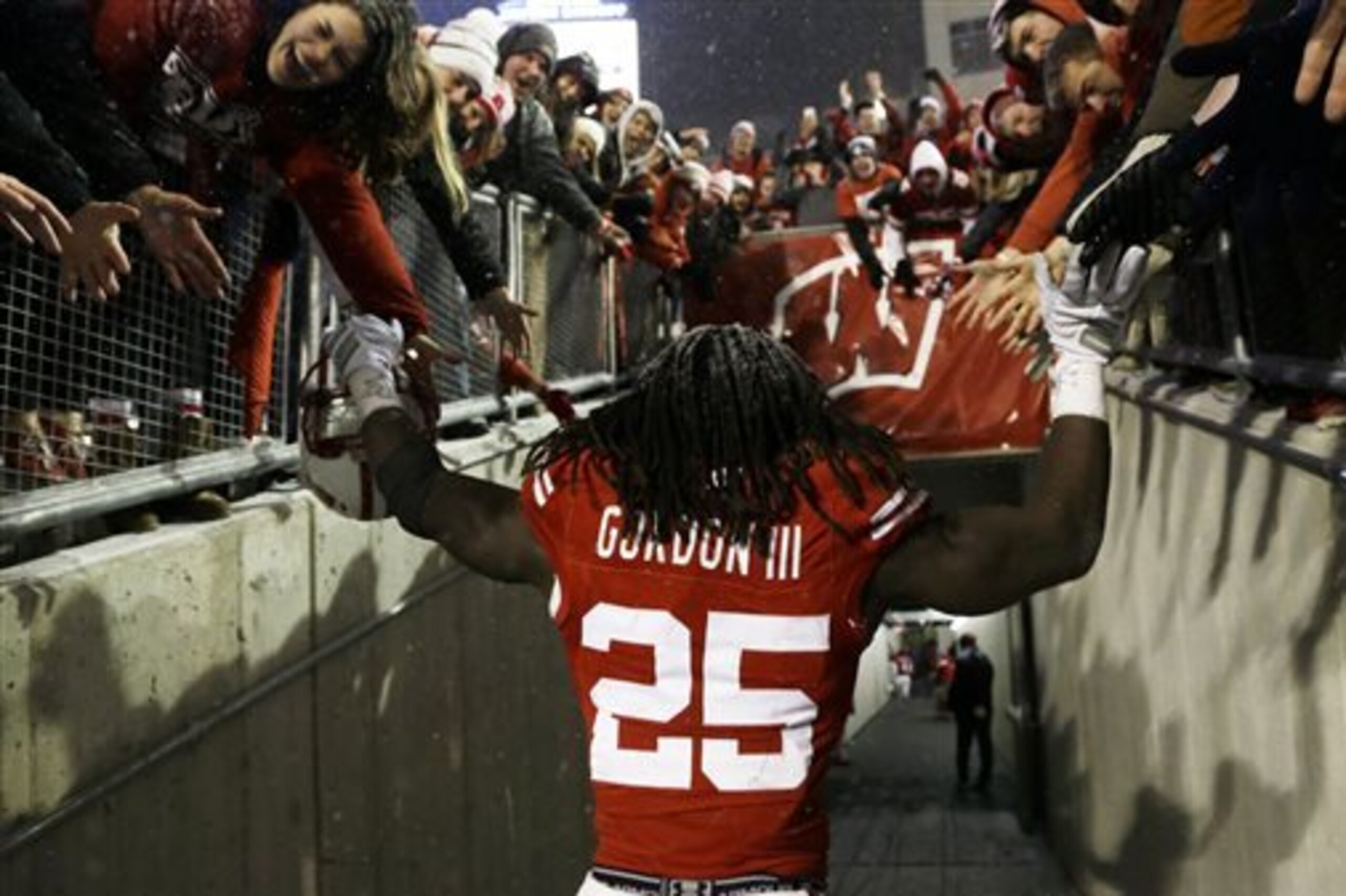 Wisconsin's Melvin Gordon celebrates with fans after their 59-24 win over Nebraska in an NCAA college football game Saturday, Nov. 15, 2014, in Madison, Wis. Gordon rushed for a major college-record 408 yards and four touchdowns in the game. (AP Photo/Morry Gash) Wisconsin's Melvin Gordon celebrates with fans after their 59-24 win over Nebraska in an NCAA college football game Saturday, Nov. 15, 2014, in Madison, Wis. Gordon rushed for a major college-record 408 yards and four touchdowns in the game. (AP Photo/Morry Gash)