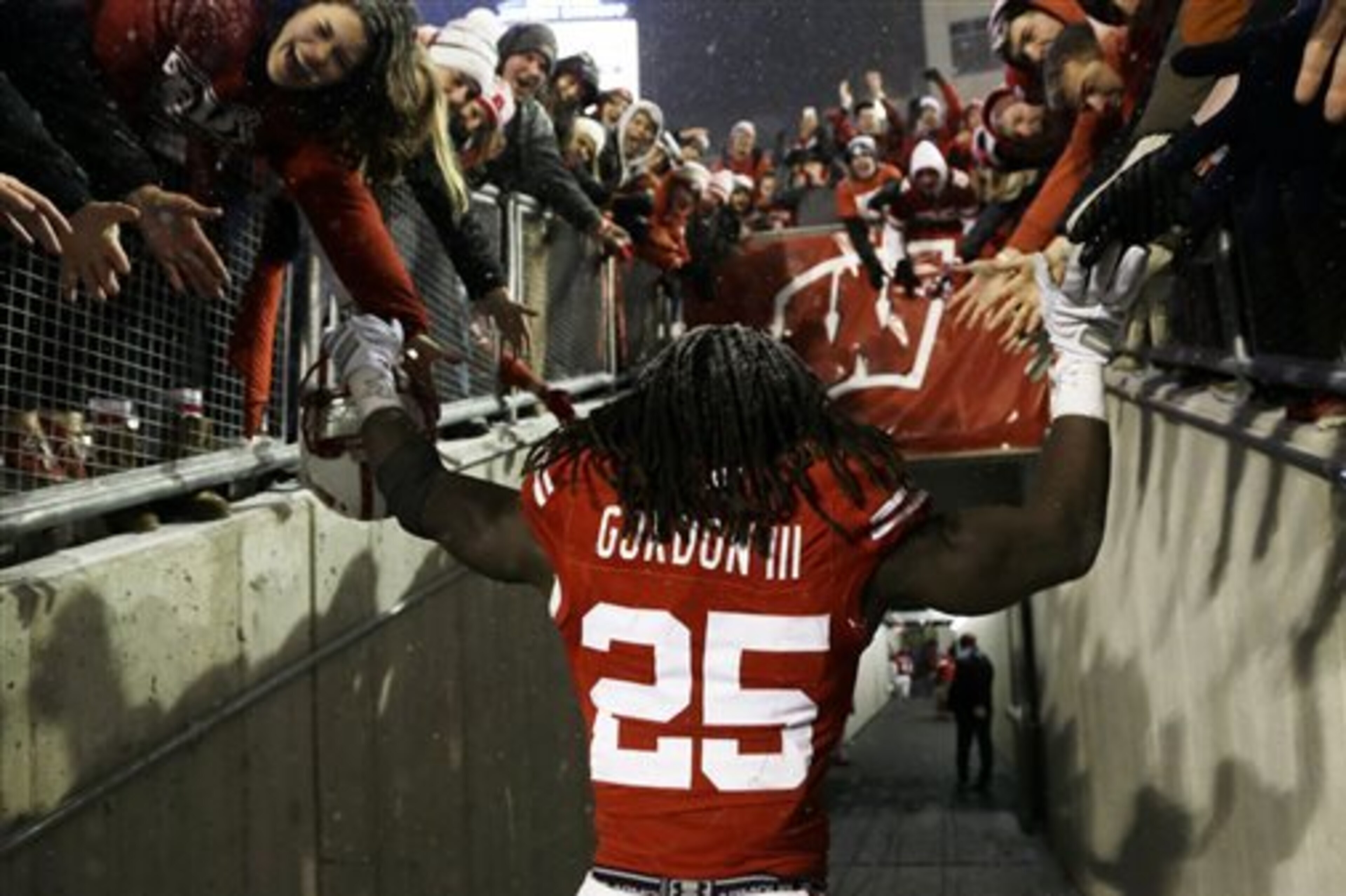 Wisconsin's Melvin Gordon celebrates with fans after their 59-24 win over Nebraska in an NCAA college football game Saturday, Nov. 15, 2014, in Madison, Wis. Gordon rushed for a major college-record 408 yards and four touchdowns in the game. (AP Photo/Morry Gash)