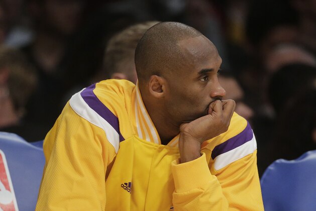 Los Angeles Lakers' Kobe Bryant sits on the bench during the first half of an NBA basketball game against the San Antonio Spurs Friday, Nov. 14, 2014, in Los Angeles. (AP Photo/Jae C. Hong)