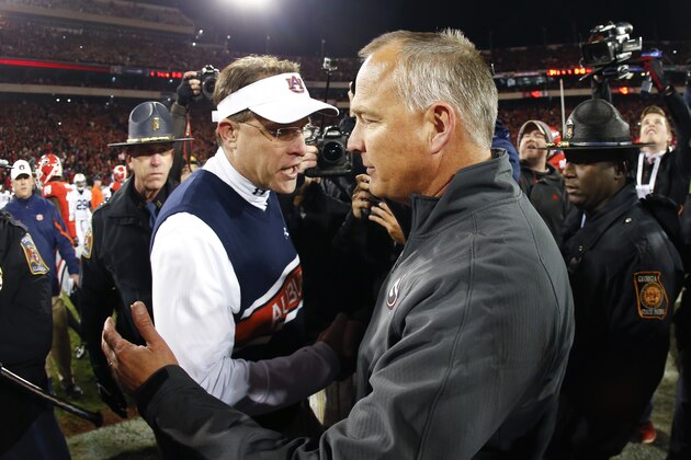 Georgia head coach Mark Richt, right, and Auburn head coach Gus Malzahn meet at midfield after an NCAA college football game Saturday, Nov. 15, 2014, in Athens, Ga. Georgia won 34-7. (AP Photo/John Bazemore)