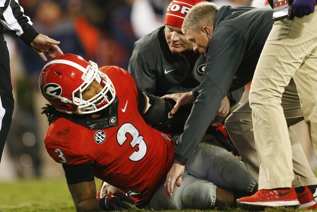 Members of the Georgia medical staff tend to injured running back Todd Gurley in the second half of an NCAA college football game  against Auburn Saturday, Nov. 15, 2014, in Athens, Ga. Georgia won 34-7. (AP Photo/John Bazemore)