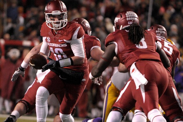 Arkansas quarterback Brandon Allen (10) prepares to hand off the ball to running back Alex Collins (3) during the first half against LSU in an NCAA college football game in Fayetteville, Ark., Saturday, Nov. 15, 2014. (AP Photo/David Quinn)