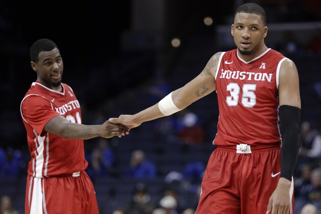 Houston's TaShawn Thomas (35) and Jherrod Stiggers, left, celebrate in the final seconds of Houston's 68-64 win in an NCAA college basketball game in the quarterfinals of the American Athletic Conference tournament Thursday, March 13, 2014, in Memphis, Tenn. (AP Photo/Mark Humphrey)