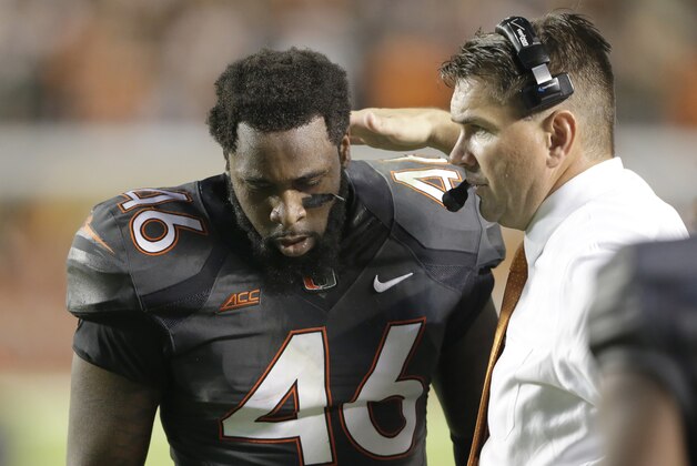 Miami head coach Al Golden, right, talks with tight end Clive Walford (46) after Walford scored a touchdown during the first half of an NCAA college football game against the Florida State, Saturday, Nov. 15, 2014, in Miami Gardens, Fla. (AP Photo/Wilfredo Lee)