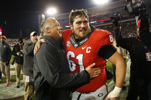 Georgia head coach Mark Richt embraces Georgia center David Andrews (61) after defeating Auburn 34-7 in an NCAA college football game Saturday, Nov. 15, 2014, in Athens, Ga. (AP Photo/John Bazemore)