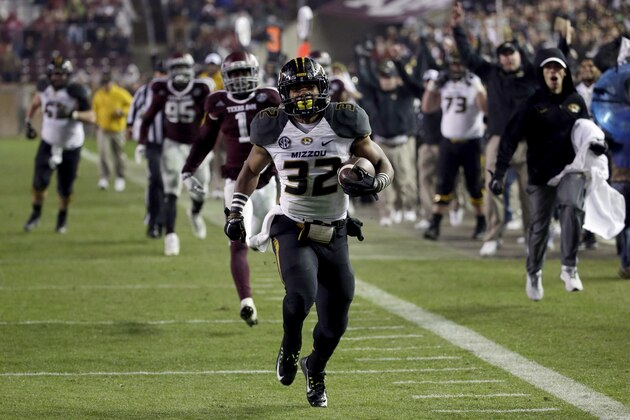 Missouri running back Russell Hansbrough (32) rushes 45 yards for a touchdown against Texas A&M during the second half of an NCAA college football game Saturday, Nov. 15, 2014, in College Station, Texas. (AP Photo/David J. Phillip)
