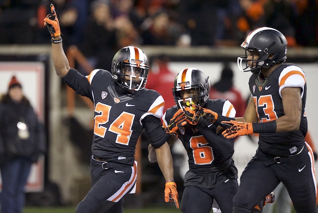 Oregon State tailback Storm Woods (24) celebrates with teammates Victor Bolden (6) and Jordan Villain (13), right, after scoring a touchdown against Arizona State during the first quarter of an NCAA college football game in Corvallis, Ore., Saturday, Nov. 15, 2014. (AP Photo/Troy Wayrynen)