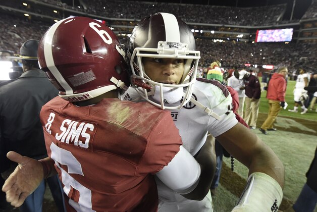 Nov 15, 2014; Tuscaloosa, AL, USA; Mississippi State Bulldogs quarterback Dak Prescott (15) and Alabama Crimson Tide quarterback Blake Sims (6) embrace following the 25-20 win by Alabama at Bryant-Denny Stadium. Mandatory Credit: John David Mercer-USA TODAY Sports