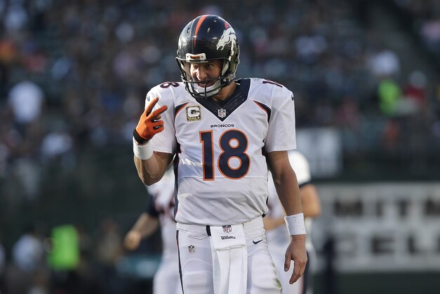 Denver Broncos quarterback Peyton Manning (18) reacts after throwing a 15-yard touchdown pass to wide receiver Emmanuel Sanders during the third quarter of an NFL football game against the Oakland Raiders in Oakland, Calif., Sunday, Nov. 9, 2014. (AP Photo/Marcio Jose Sanchez)