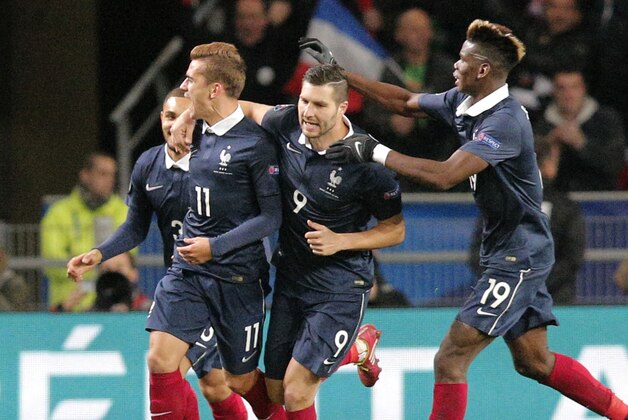 France's Antoine Griezmann, left, celebrates with his teammates the equalizer during a friendly soccer match France against Albania at Route de Lorient stadium in Rennes, western France, Friday, Nov. 14, 2014. The match ended in a 1-1 draw. (AP Photo/Michel Euler)