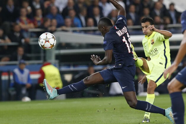 PSG's Blaise Matuidi, left, tries to block a shot by Barcelona's Pedro Rodriguez, right, during the Champions League Group F soccer match between Paris Saint German and Barcelona at Parc des Princes stadium in Paris, France, Tuesday, Sept. 30, 2014. (AP Photo/Michel Euler)