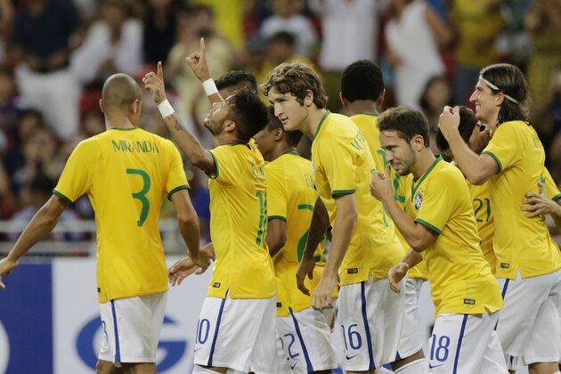 Brazil's Neymar second left, celebrates with his teammates after scoring a goal against Japan during an international friendly soccer match in Singapore, Tuesday, Oct. 14, 2014 in Singapore. (AP Photo/Wong Maye-E)