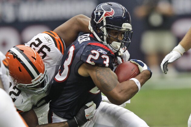 Houston Texans running back Arian Foster (23) and Cleveland Browns defensive end Jayme Mitchell (92) in the first quarter of an NFL football game Sunday, Nov. 6, 2011, in Houston. (AP Photo/David J. Phillip)