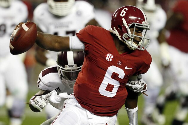 Alabama quarterback Blake Sims (6) runs with the ball away from Mississippi State linebacker Matthew Wells during the second half of an NCAA college football game on Saturday, Nov. 15, 2014, in Tuscaloosa, Ala. (AP Photo/Butch Dill)