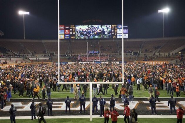Oregon State football fans rush the field at the end of an NCAA college football game against Arizona State in Corvallis, Or., Saturday, Nov. 15, 2014. The Beavers beat the Sun Devils 35-27. (AP Photo/Troy Wayrynen)