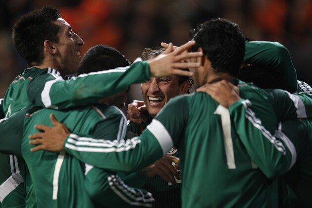 Mexico players celebrate after Mexico's Javier Hernandez scored a goal during the international friendly soccer match between the Netherlands and Mexico at ArenA stadium in Amsterdam, Netherlands, Wednesday, Nov. 12, 2014. (AP Photo/Peter Dejong)