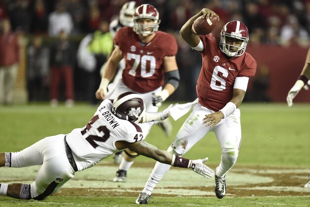 Nov 15, 2014; Tuscaloosa, AL, USA; Alabama Crimson Tide quarterback Blake Sims (6) carries the ball for a first down past Mississippi State Bulldogs linebacker Beniquez Brown (42) in the fourth quarter at Bryant-Denny Stadium. Mandatory Credit: John David Mercer-USA TODAY Sports