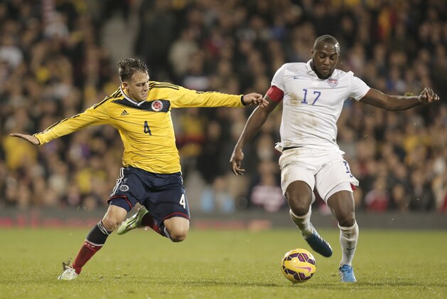 Colombia's Santiago Arias, left, fights for the ball with USA's captain Josy Altidore, right, during an international friendly soccer match against USA at the Craven Cottage ground in London, Friday, Nov. 14, 2014. Colombia won the match 2-1. (AP Photo/Lefteris Pitarakis)
