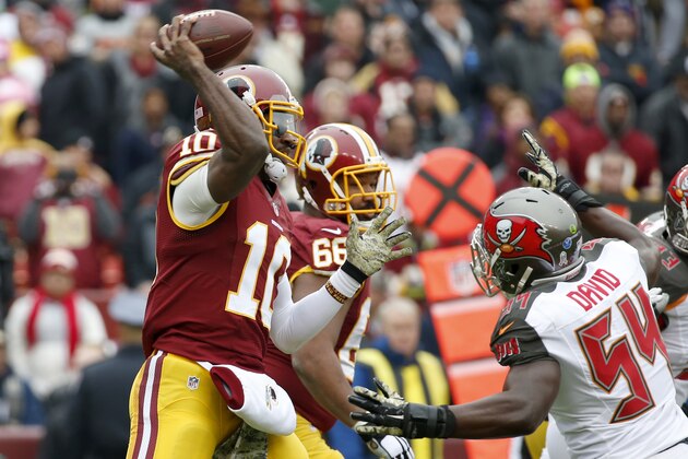 Washington Redskins quarterback Robert Griffin III (10) throws under pressure from Tampa Bay Buccaneers outside linebacker Lavonte David (54) during the first half of an NFL football game in Landover, Md., Sunday, Nov. 16, 2014. (AP Photo/Alex Brandon)