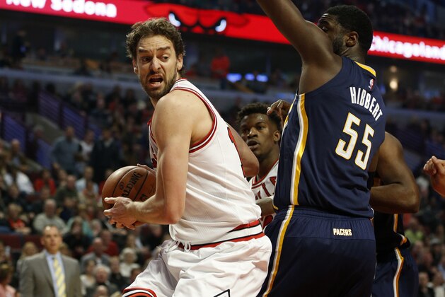 Chicago Bulls forward Pau Gasol, left, drives past Indiana Pacers center Roy Hibbert (55) during the first half of an NBA basketball game on Saturday, Nov. 15, 2014, in Chicago. (AP Photo/Andrew A. Nelles)