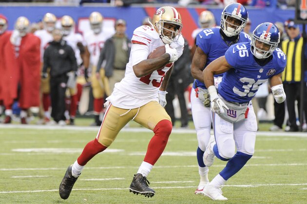 San Francisco 49ers wide receiver Michael Crabtree (15) runs away from New York Giants' Quintin Demps (35) and Jameel McClain (53) for a touchdown during the second half of an NFL football game Sunday, Nov. 16, 2014, in East Rutherford, N.J.  (AP Photo/Bill Kostroun)