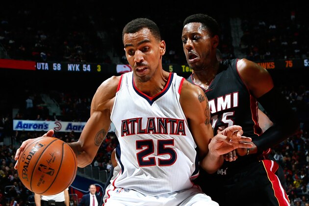 ATLANTA, GA - NOVEMBER 14:  Mario Chalmers #15 of the Miami Heat defends against Thabo Sefolosha #25 of the Atlanta Hawks at Philips Arena on November 14, 2014 in Atlanta, Georgia.  NOTE TO USER: User expressly acknowledges and agrees that, by downloading and or using this photograph, User is consenting to the terms and conditions of the Getty Images License Agreement.  (Photo by Kevin C. Cox/Getty Images)