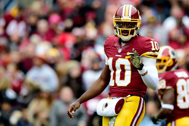 LANDOVER, MD - NOVEMBER 16:  Quarterback Robert Griffin III #10 of the Washington Redskins signals to the sideline during the first quarter of a game against the Tampa Bay Buccaneers at FedExField on November 16, 2014 in Landover, Maryland.  (Photo by Patrick McDermott/Getty Images)