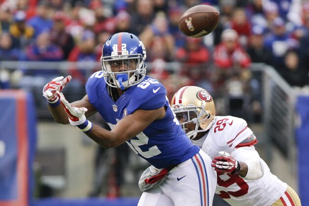 New York Giants wide receiver Rueben Randle (82) watches a ball as he is defended by San Francisco 49ers' Chris Culliver (29) during the first half of an NFL football game Sunday, Nov. 16, 2014, in East Rutherford, N.J.  (AP Photo/Julio Cortez)