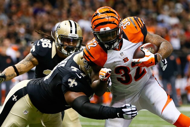 NEW ORLEANS, LA - NOVEMBER 16:   Jeremy Hill #32 of the Cincinnati Bengals is tackled by  Brodrick Bunkley #77 of the New Orleans Saints during the first quarter at Mercedes-Benz Superdome on November 16, 2014 in New Orleans, Louisiana.  (Photo by Kevin C. Cox/Getty Images)