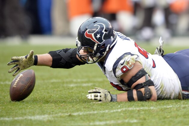 Houston Texans defensive end J.J. Watt recovers a Cleveland Browns' fumble in the second quarter of an NFL football game Sunday, Nov. 16, 2014, in Cleveland. (AP Photo/David Richard)