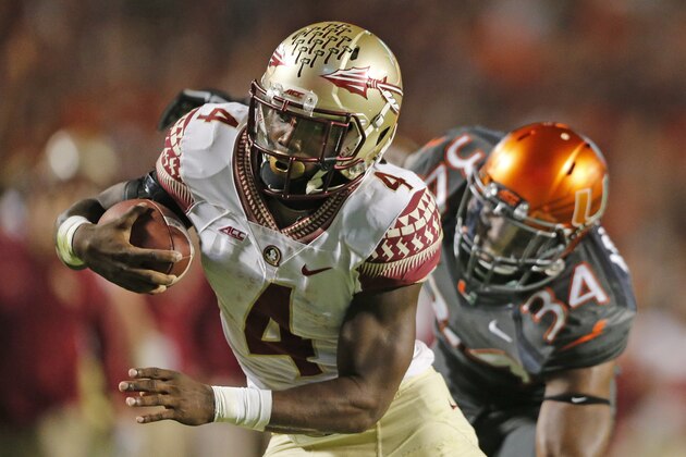 MIAMI GARDENS, FL - NOVEMBER 15: Dalvin Cook #4 of the Florida State Seminoles scores the winning touchdown in the fourth quarter against the Miami Hurricanes on November 15, 2014 at Sun Life Stadium in Miami Gardens, Florida. The Seminoles defeated the Hurricanes 30-26. (Photo by Joel Auerbach/Getty Images)