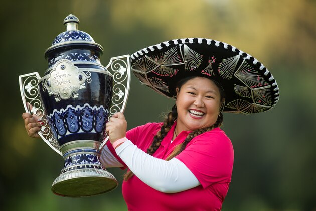 MEXICO CITY, MEXICO - NOVEMBER 16:  Christina Kim of the United States holds the champions trophy after her victory at the 2014 Lorena Ochoa Invitational presented by Banamex at Club de Golf Mexico on November 16, 2014 in Mexico City, Mexico.  (Photo by Darren Carroll/Getty Images)