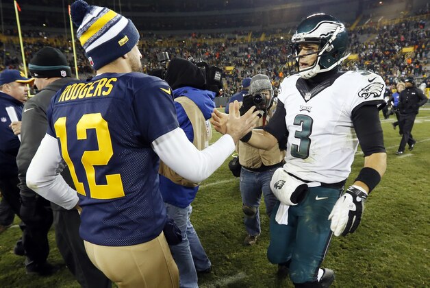 Green Bay Packers' Aaron Rodgers (12) shakes hands with Philadelphia Eagles' Mark Sanchez after an NFL football game Sunday, Nov. 16, 2014, in Green Bay, Wis. The Packers won 53-20. (AP Photo/Mike Roemer)