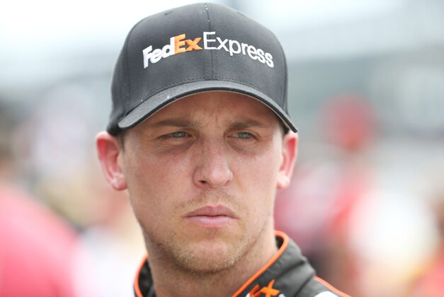 Jul 26, 2014; Indianapolis, IN, USA; NASCAR Sprint Cup driver Denny Hamlin watches in the pits during qualifying for the Crown Royal Brickyard 400 at Indianapolis Motor Speedway. Mandatory Credit: Brian Spurlock-USA TODAY Sports