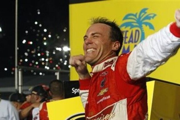 Kevin Harvick celebrates after winning the NASCAR Sprint Cup championship series auto race, Sunday, Nov. 16, 2014, in Homestead, Fla. (AP Photo/Terry Renna)