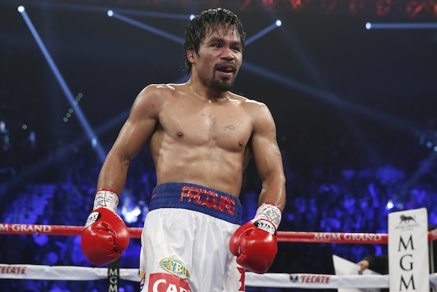 Manny Pacquiao returns to his corner during his WBO welterweight title boxing fight against Timothy Bradley Saturday, April 12, 2014, in Las Vegas. (AP Photo/Eric Jamison)