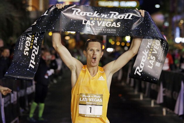 Ben Bruce celebrates after winning the Rock 'n' Roll Las Vegas Marathon along the Las Vegas Strip, Sunday, Nov. 16, 2014, in Las Vegas. (AP Photo/John Locher)